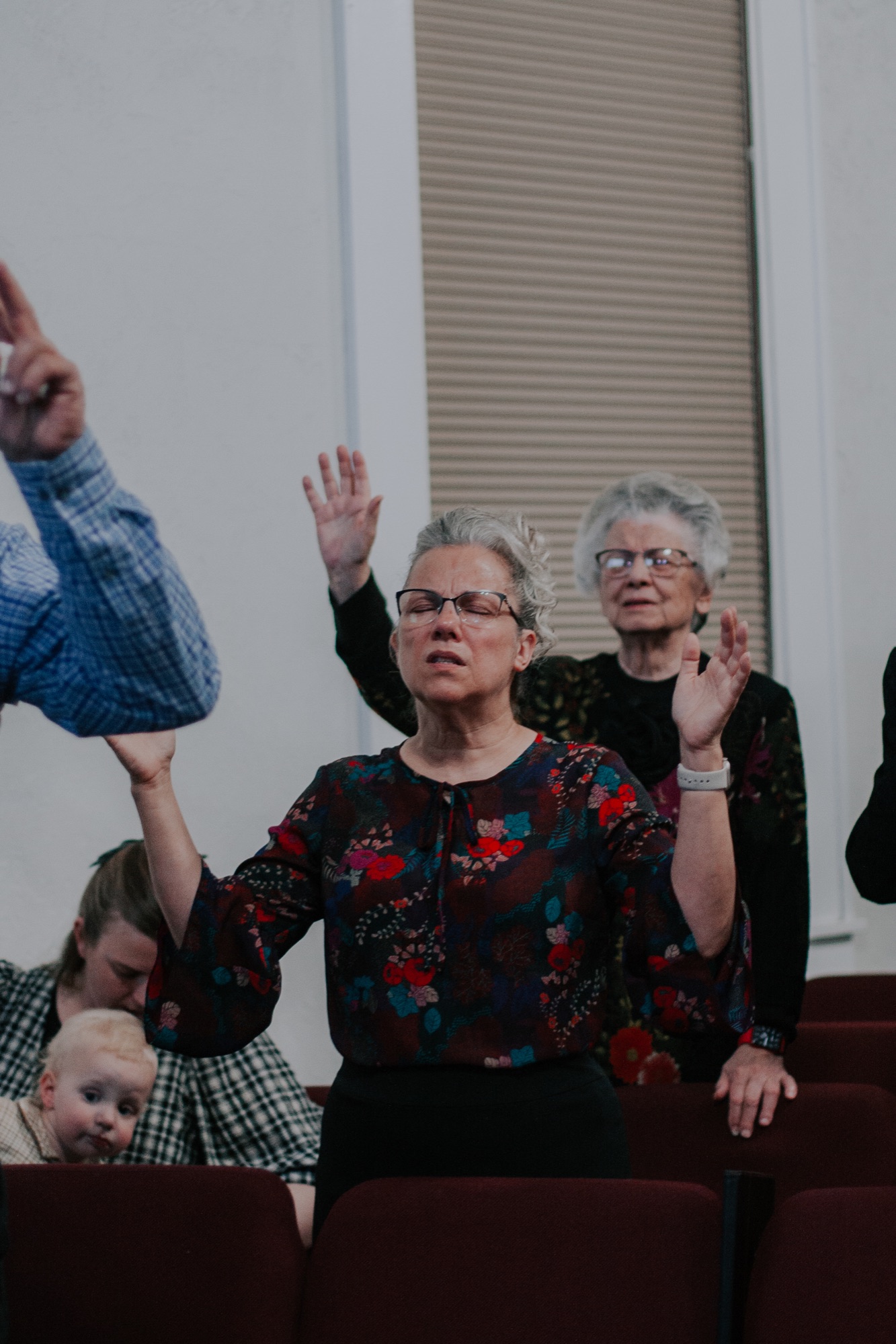 The pastor's wife praying during worship